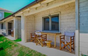 a patio with chairs and a table in front of a house at White house in Donji Štoj