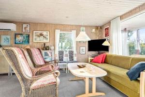 a living room with a couch and chairs and a table at LF14218-Roslev-Skovsovej-4 in Roslev