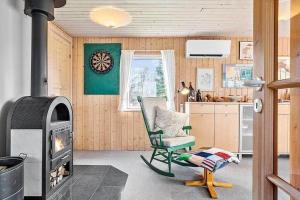 a living room with a chair and a fireplace at LF14218-Roslev-Skovsovej-4 in Roslev +22 photos