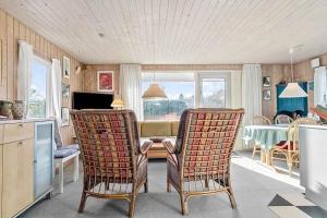 a living room with a table and two chairs at LF14218-Roslev-Skovsovej-4 in Roslev