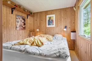 a bedroom with two beds in a room with wooden walls at LF14218-Roslev-Skovsovej-4 in Roslev