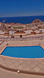 a large swimming pool with the ocean in the background at Chalet in Porto Sokhna Hanging Gardens - Fifth Terrace Sea View شاليه في بورتو السخنة - الحدائق المعلقة - المصطبة الخامسة - إطلالة بحر مباشر in Ain Sokhna +21 photos