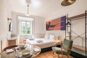 a bedroom with a bed and a table and chairs at Pendoa Sintra Collection-Soft Opening in Sintra