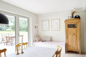 a dining room with a table and chairs and a window at 13365-Asnaes-Radyrvej-63 in Asnæs
