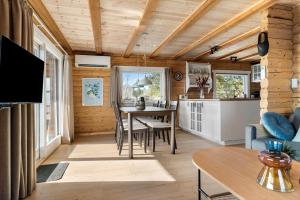 a living room with a table and a kitchen at 0132-Romo-Kap-Farvel-12 in Høm