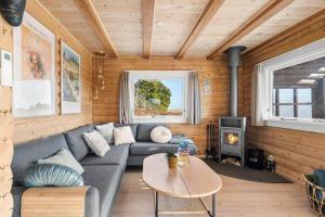 a living room with a couch and a stove at 0132-Romo-Kap-Farvel-12 in Høm