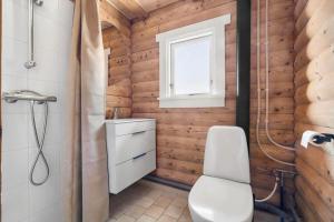 a bathroom with a white toilet and a shower at 0132-Romo-Kap-Farvel-12 in Høm +25 photos