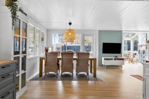 a kitchen and dining room with a table and chairs at LF15233-Hojslev-Jelsevej-261 in Højslev
