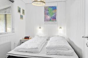 a white bedroom with a bed with white sheets at LF15233-Hojslev-Jelsevej-261 in Højslev