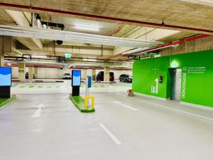 an empty parking garage with a green wall at M2Suites by BestChoice - Messe - Parking - Self-Check-in in Graz
