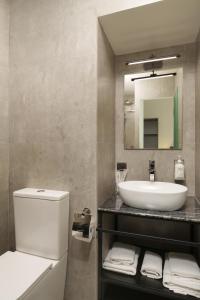 a bathroom with a sink and a toilet and a mirror at Elysium Gallery Hotel in Yerevan +17 photos