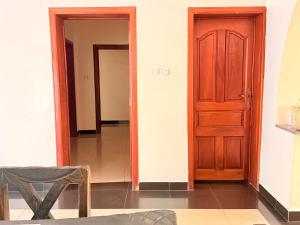 a hallway with a door and a table and a chair at Volcanoes Stay Musanze in Kigali