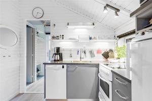 a white kitchen with a sink and a dishwasher at 13338-Asnaes-Hogevej-22 in Asnæs