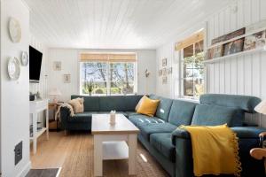 a living room with a blue couch and a table at 0025-Romo-P-J-Manosvej-18 in Høm