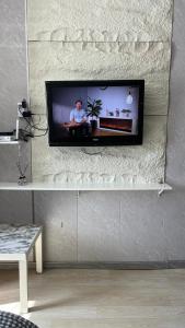 a flat screen tv on a wall in a living room at Studio in Darhan