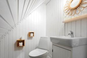 a white bathroom with a sink and a toilet at 0025-Romo-P-J-Manosvej-18 in Høm +26 photos