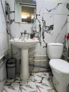 a bathroom with a sink and a toilet at Studio in Darhan