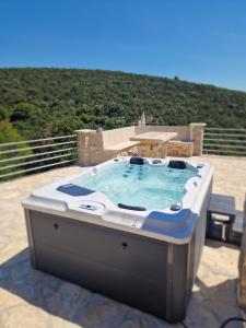 a hot tub sitting on top of a patio at Robinson Hideaway Korčula in Korčula