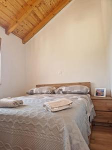 a bedroom with a bed with two pillows on it at Robinson Hideaway Korčula in Korčula +9 photos