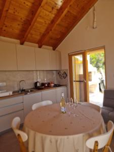 a kitchen with a table with wine glasses on it at Robinson Hideaway Korčula in Korčula