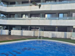 an empty swimming pool in front of a building at Belice 1-6 in Lloret de Mar