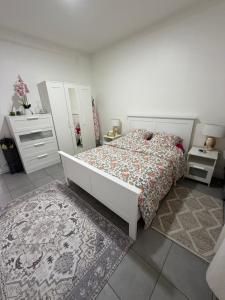 a bedroom with a bed and two night stands at Spacieux et lumineux, coup de cœur garanti à proximité du métro et RER in La Courneuve