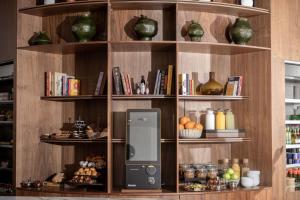 a book shelf with an electronic device on it at Metro Hotel Herzliya in Herzliya B +10 photos