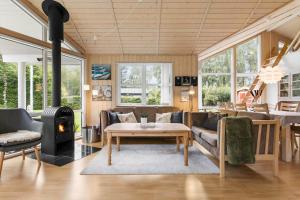 a living room with a couch and a table at LF15149-Farso-Ramshule-49 in Farsø