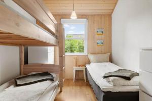 a bedroom with two bunk beds and a window at LF15149-Farso-Ramshule-49 in Farsø