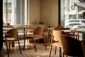 a room with tables and chairs in a restaurant at Metro Hotel Herzliya in Herzliya B