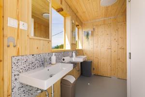 a bathroom with two sinks and a mirror at Glamping Slavica in Dramlje