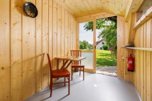 a room with a table and chairs and a window at Glamping Slavica in Dramlje