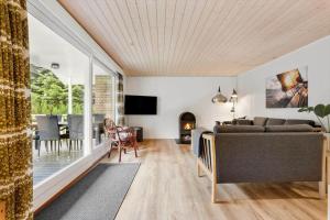 a living room with a couch and a fireplace at LF16244-Logstor-Mollysvej-44 in Løgstør