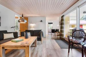 a living room with a couch and a table at LF16244-Logstor-Mollysvej-44 in Løgstør