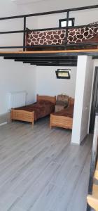 two beds in a room with a loft at Auto in Surami