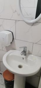 a bathroom with a white sink and a mirror at Auto in Surami