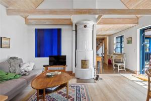 a living room with a couch and a fireplace at 16642-Farevejle-Vindekilde-Strandvej-30 in Fårevejle