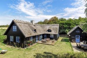 a large black house with a roof at 16642-Farevejle-Vindekilde-Strandvej-30 in Fårevejle