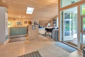 a large room with a kitchen and a dining room at 13346-Hojby-Digevaenget-8 in Højby +13 photos