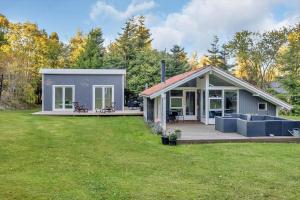 a tiny house with a porch and a deck at 13346-Hojby-Digevaenget-8 in Højby