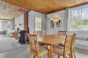 a dining room with a wooden table and chairs at LF14221-Roslev-Astrup-Vig-81 in Roslev +11 photos
