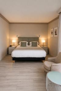 a bedroom with a bed with two lamps and a couch at Boutique Hotel B51 in Marbella +101 photos
