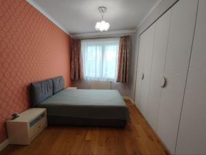 a small bedroom with a bed and a window at Stylish central apartment in Trenčín
