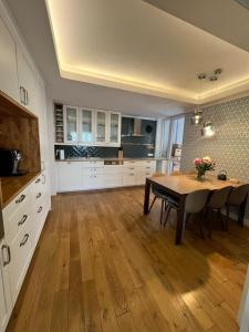 a kitchen with a table and a dining room at Stylish central apartment in Trenčín
