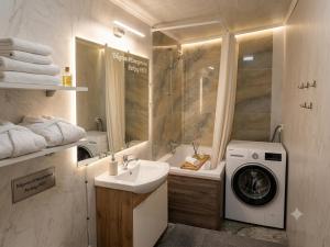 a bathroom with a washing machine and a sink at 31 August 1989 N 59 Hotel apart in Chişinău +6 photos