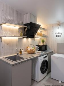 a kitchen with a sink and a washing machine at 31 August 1989 N 59 Hotel apart in Chişinău