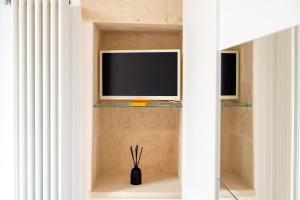 a tv sitting on a shelf in a room at Al Vecchio Cinema Martano in Martano
