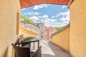 a balcony with chairs and a view of buildings at Apartmány Nerudova in Vítkovice