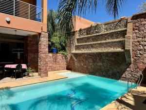 a swimming pool in front of a house at Atlas View Luxury Villa in Ourika