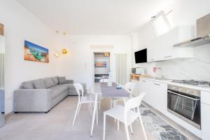 a kitchen and living room with a table and a couch at Al Vecchio Cinema Martano in Martano
